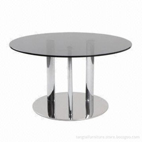 Round coffee table made of glass and stainless steel